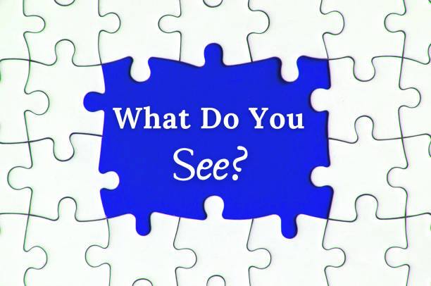 istock Text on missing jigsaw puzzle - What do you see. With blue background. 1385433703