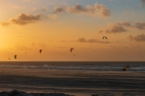 Kitesurfer at Kijkduin North Sea beach at sunset