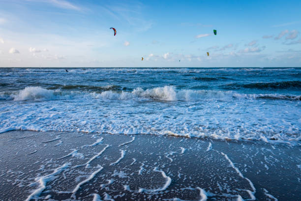 istock North Sea beach with surf, waves and kitesurfer 1385434065