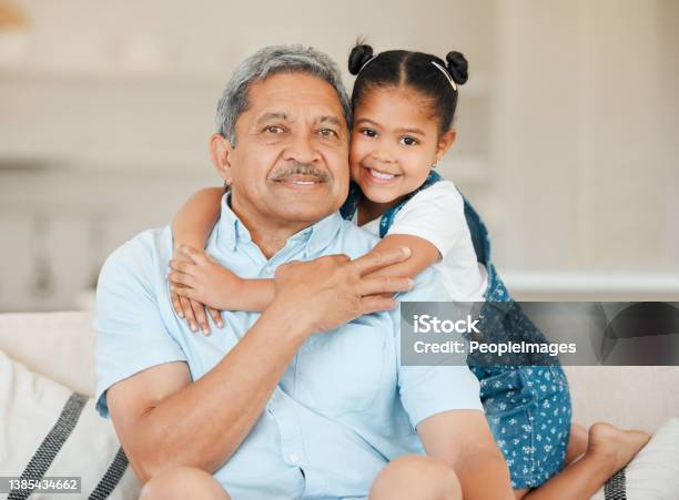 Shot Of A Grandfather And Granddaughter Bonding On The Sofa At Home Stock Photo - Download Image Now