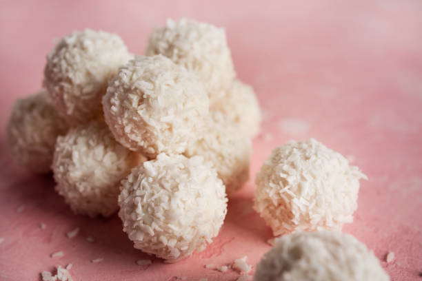 istock Coconut candies with nuts on pink background. Raffaello 1385440359