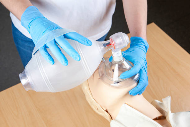 istock First Aid. Bag-Valve-Mask (BVM) Ventilation. Demonstration on a cpr dummy 1385441564