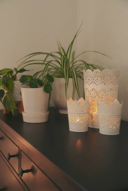 istock Candles and plants on a dresser. 1385441667