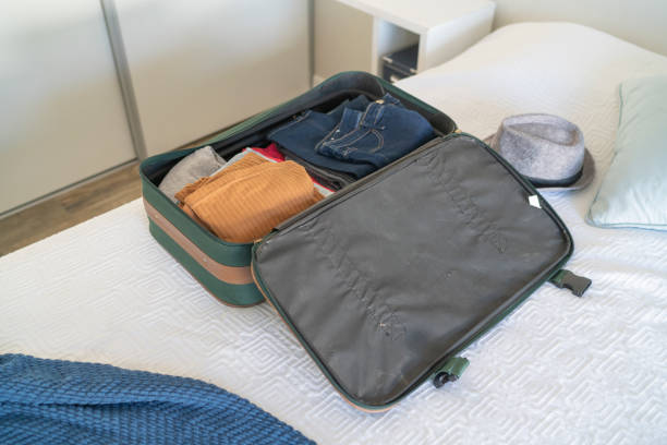 istock Open hand luggage on  bed at hotel room 1385442992