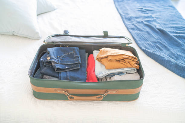 istock Open hand luggage on  bed at hotel room 1385442996