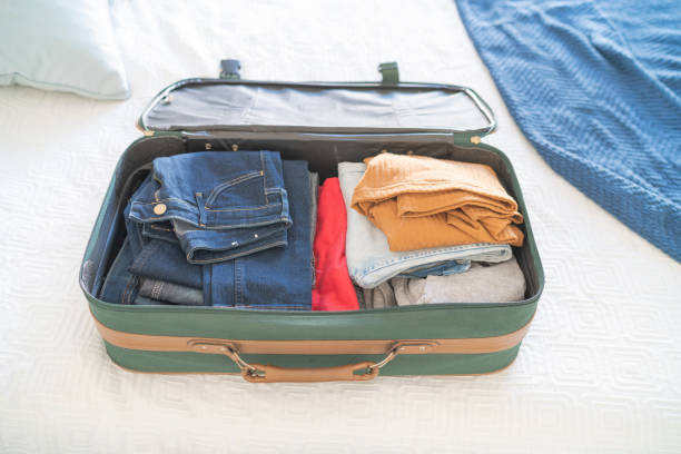 istock Open hand luggage on  bed at hotel room 1385442999
