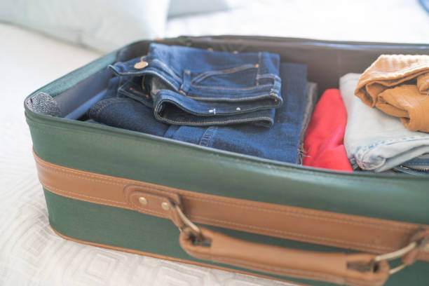 istock Open hand luggage on  bed at hotel room 1385443006