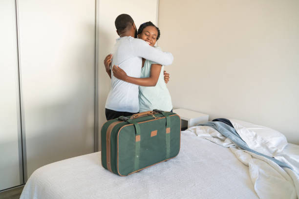 istock Black couple embracing before man going on a trip 1385443026
