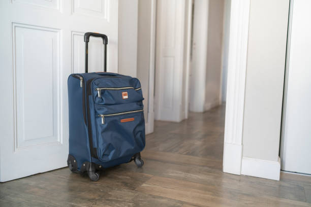istock Carry-on luggage on hallway 1385443065