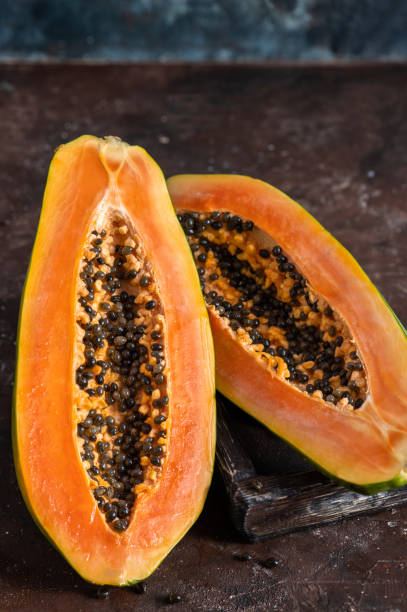 istock sliced papaya on wooden background 1385444235