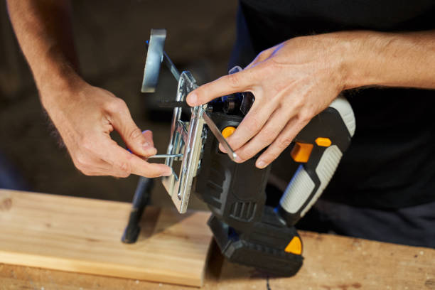 istock men's hands set up a jigsaw with a battery with a key 1385444241