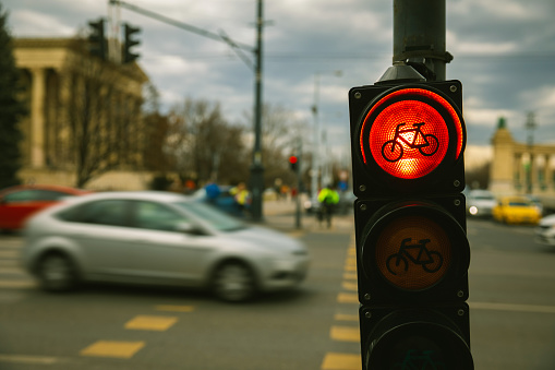 Photograph of a red traffic light for bicycles, seen from close up in a city