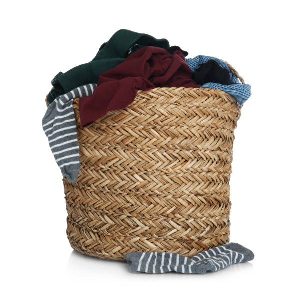 istock Wicker laundry basket with clothes isolated on white 1385446339