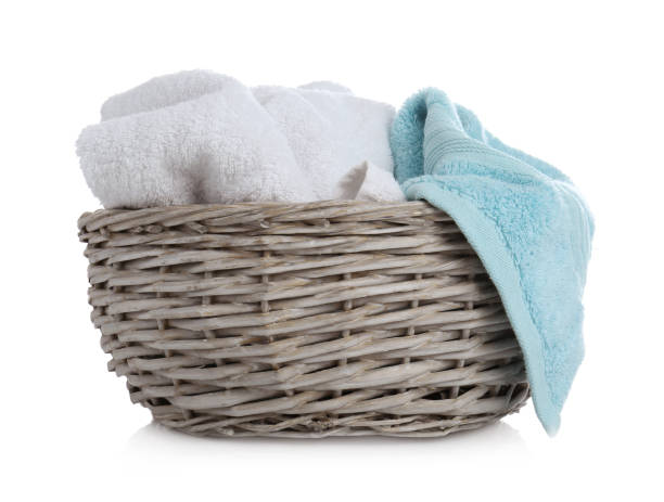 istock Wicker basket with towels isolated on white 1385446342