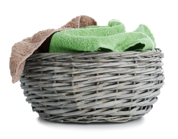 istock Wicker basket with towels isolated on white 1385446358