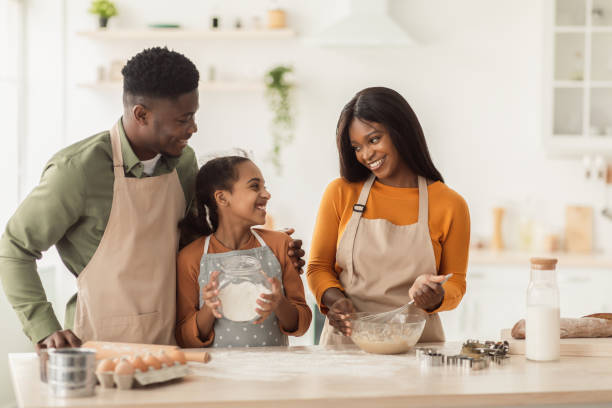 istock African American Family Baking Mixing Ingredients Making Dough In Kitchen 1385450437