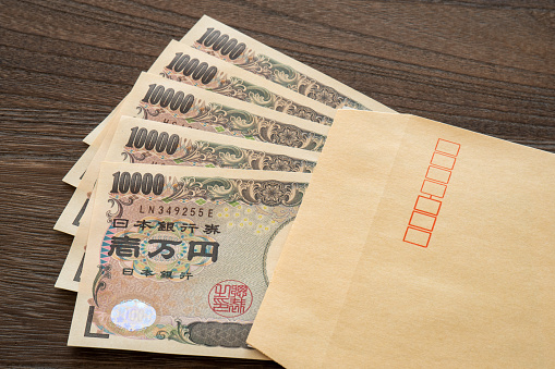 Japanese 50,000 yen banknote in an envelope