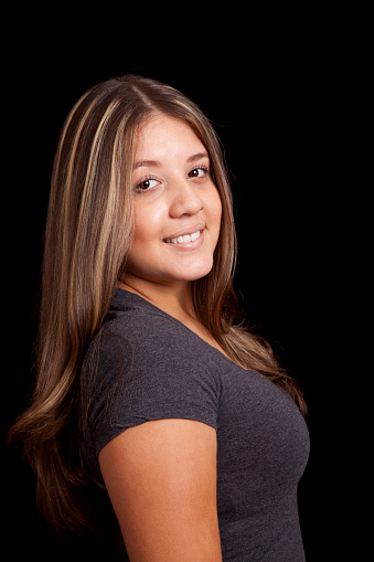 Portrait of female with light brown hair and blond hair highlights, studio shot.