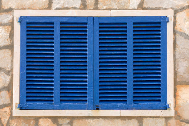 old window with colorful wooden shutters