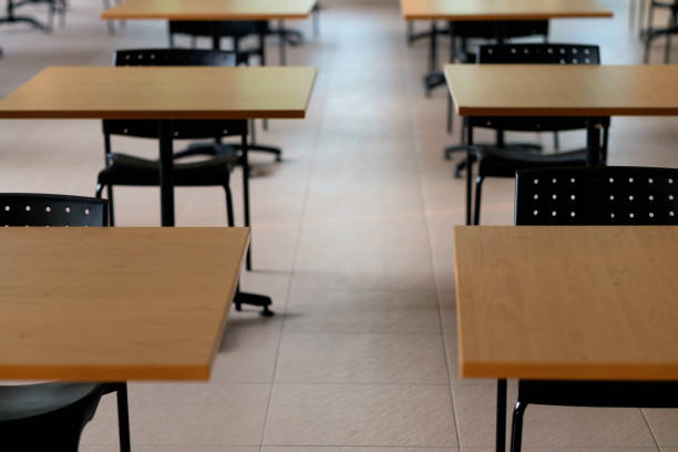 istock Tables and chairs that is arranged spaced or social distancing in the dining room without people. 1385457929