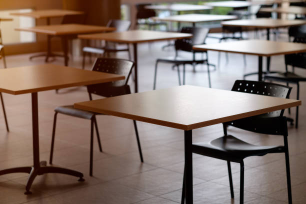 istock Tables and chairs that is arranged spaced or social distancing in the dining room without people. 1385458118