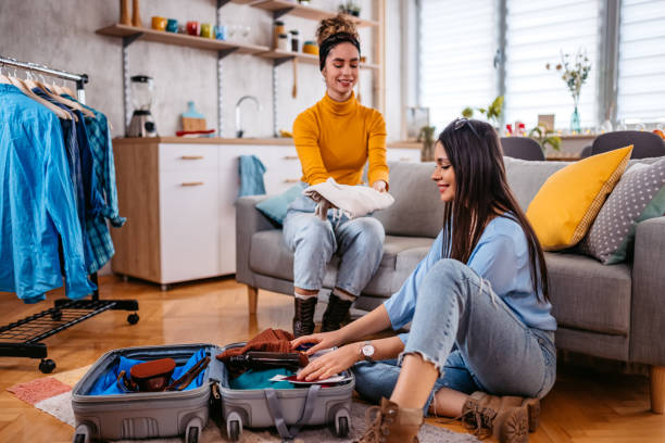 istock Two Female Friends Packing For A Trip 1385461390