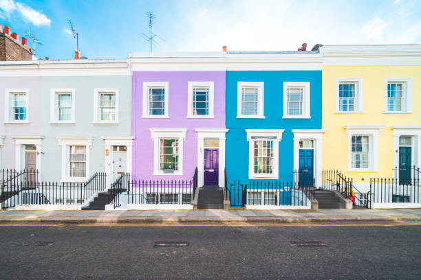 Colorful English houses facades, pastel pale colors in London Colorful English houses facades, pastel pale colors in London notting hill stock pictures, royalty-free photos & images