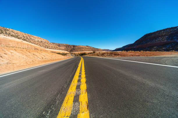 Desert Landscapes and Mountain Structures of Vibrant Red Sandstone On Curved and Winding Highway 141 Double Yellow Center Line in Western Colorado - 4K Video Available shot with focal distance and composition variations (photos professionally retouched)