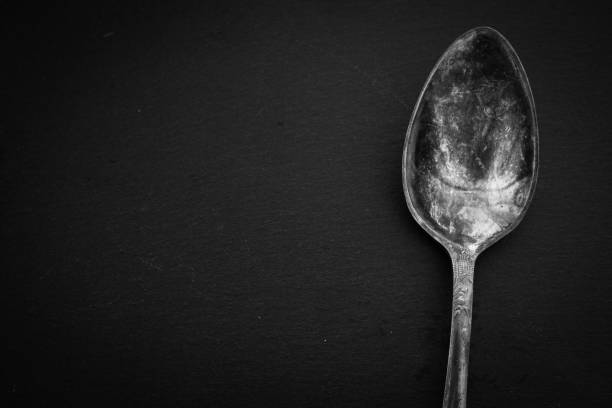 istock Antique cutlery on black background. Silver spoon isolated, black and white. Silverware with copy space. Silver cutlery. Stylish retro utensil. Vintage kitchen tools. 1385466033