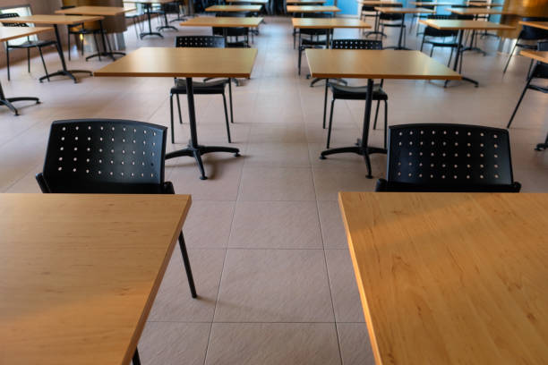istock Tables and chairs that is arranged spaced or social distancing in the dining room without people. 1385467250