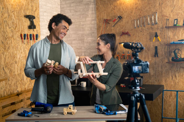 istock Two people in a carpentry workshop being filmed with a camera for a blog 1385469445