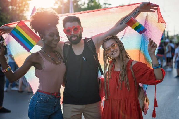 istock Friends gathering at the LGBTQI pride parade and waving rainbow flags 1385471636