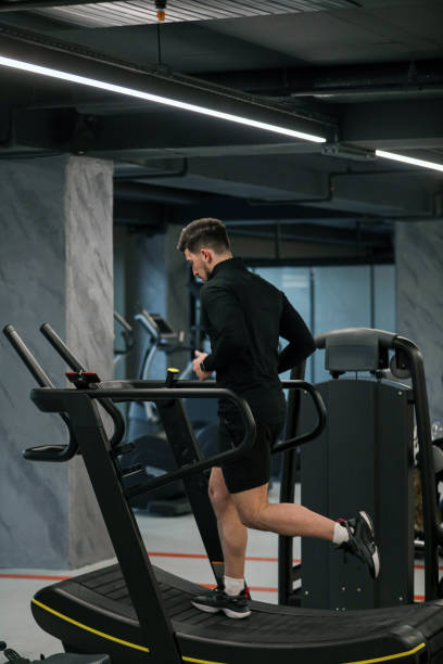 istock Healthy And Strong Young Man Exercising With Treadmill in Gym 1385471692