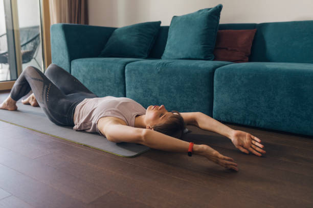 istock Healthy Lifestyle: a Beautiful Woman Doing Relaxing Yoga Exercise at Home 1385471949