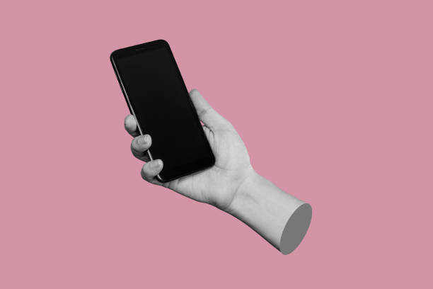 Mobile phone with black screen in female hand isolated on a pink color background Mobile phone with black screen in female hand isolated on a pink color background. Blank with an empty copy space for the text. Trendy collage in magazine urban style. Contemporary art. Modern design mobile sculpture stock pictures, royalty-free photos & images