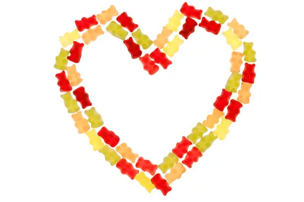 Jelly bears candy on a white background.Gummy bear heart.candy heart.Jelly lowcalorie sweet. Children's dessert.Jelly multicolored bears assorted.Sweet pattern in yellow and red colors.