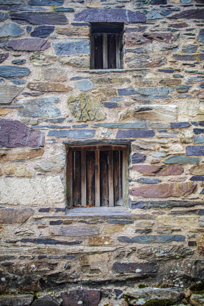istock Old medieval windows in an old old slate stone cottage 1385476841