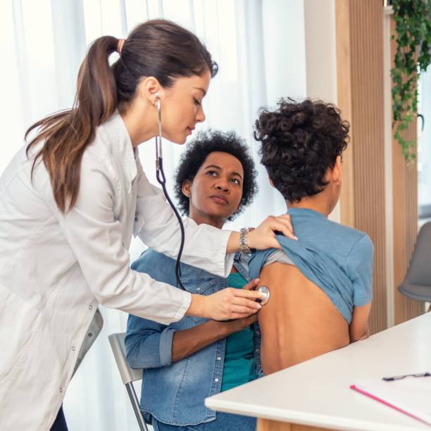 istock Female pediatrician hold stethoscope exam child boy patient 1385477321