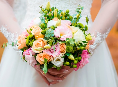 Wedding couple hand holding flower bouquet