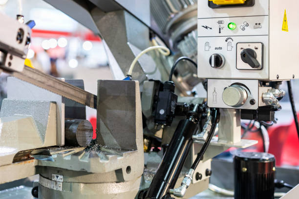 istock Close up Round shaft steel is being cutting by automatic continuous and high speed horizontal band saw machine for industrial 1385483009
