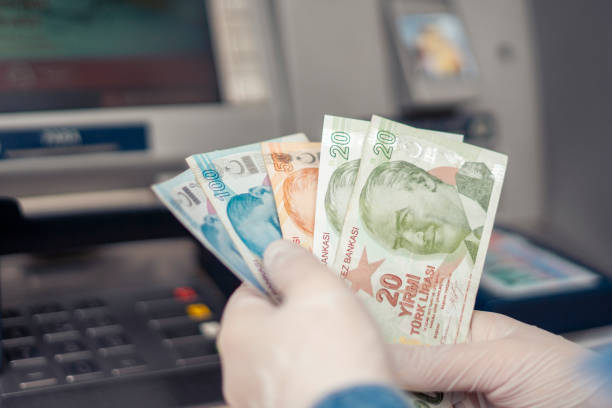 Turkish woman Hands Giving Money or Withdrawing cash to ATM/Bank stock photo