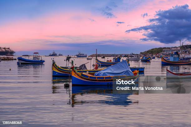 Traditional Maltese Boats In Marsaxlokk Harbor During Sunset Malta Stock Photo - Download Image Now