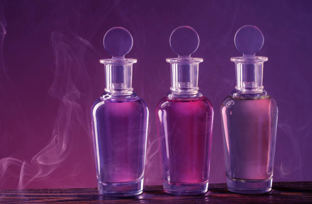 istock bottles with magic potion in smoke on purple background 1385490308