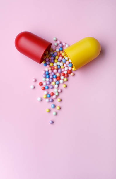 istock Open Capsule With Colorful Little Balls 1385490324