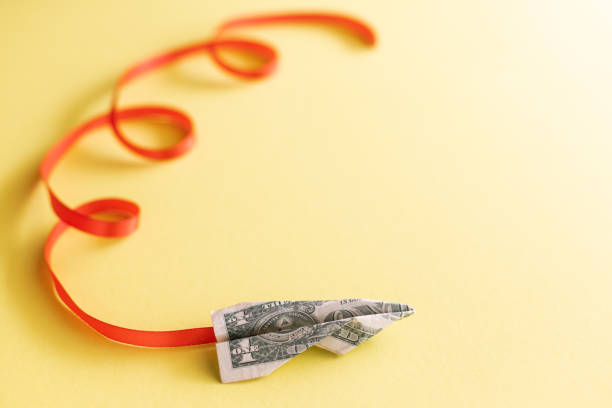 istock Paper plane made of one dollar bill. 1385492276