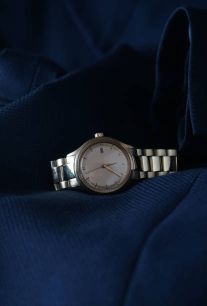 istock Elegant wrist watch closeup on blue background 1385494444