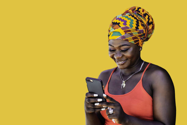 istock Happy African woman with phone in hand 1385496479