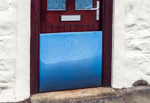 A flood defense barrier in the doorway of a British house.