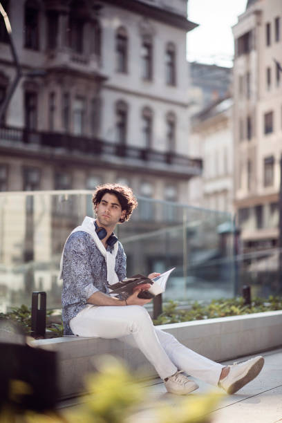 istock Young man using smart phone in the city 1385501896