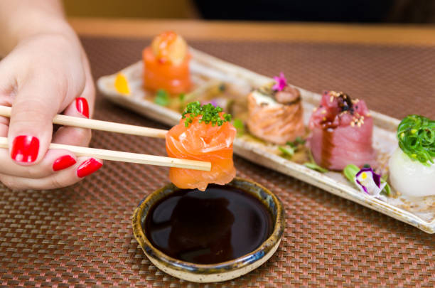 istock Woman eating delicious sushi 1385501994